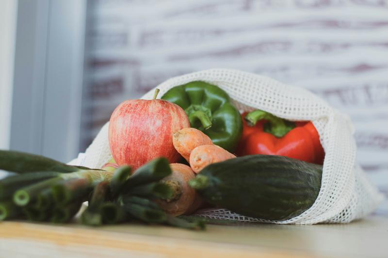 Cloth mesh produce bags filled with fresh vegetables