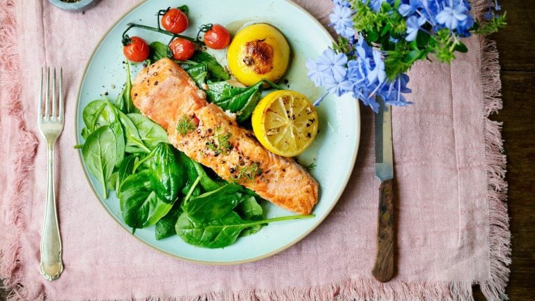 Baked salmon fillet on spinach