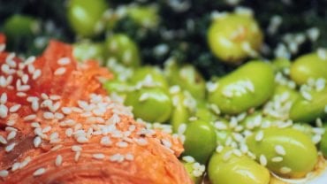 A plate of salmon, edamame and kale, three foods linked to hormonal health