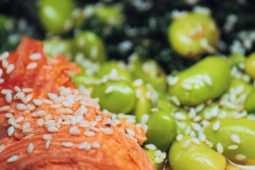 A plate of salmon, edamame and kale, three foods linked to hormonal health