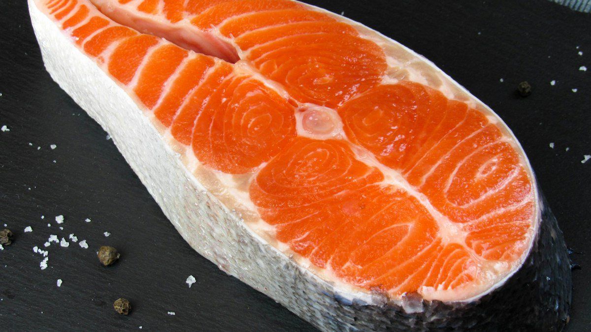 A raw salmon steak, a source of omega-3 fatty acids